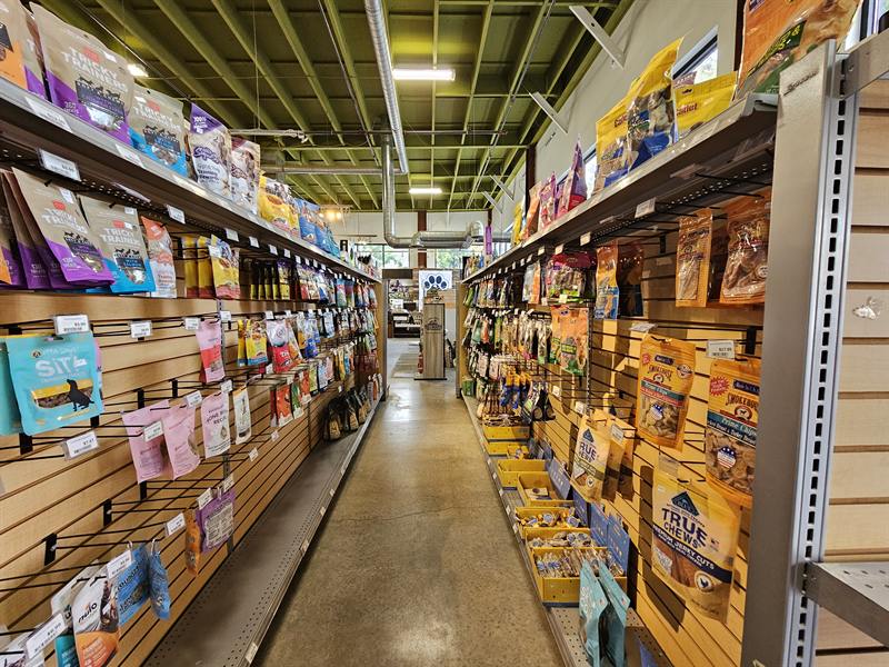 An aisle lined with bags of treats on slatwall